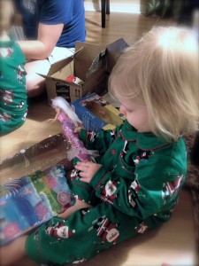 Toddler opening a Barbie