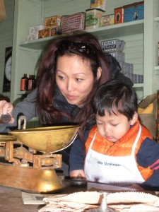 Playing shopkeeper at the General Store. Photo compliments of Dallas Heritage Village.