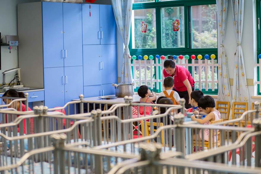 A caseworker with children at an adoption agency or orphanage.