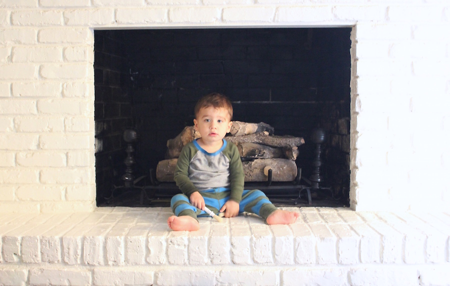 Teaching children to respect boundaries takes time. He is not allowed on the fireplace, but clearly this is still a work in progress. 