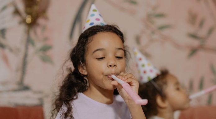 child with party blower, DIY birthday party tips