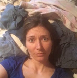 This hot mess mom laying on top of laundry mountain!