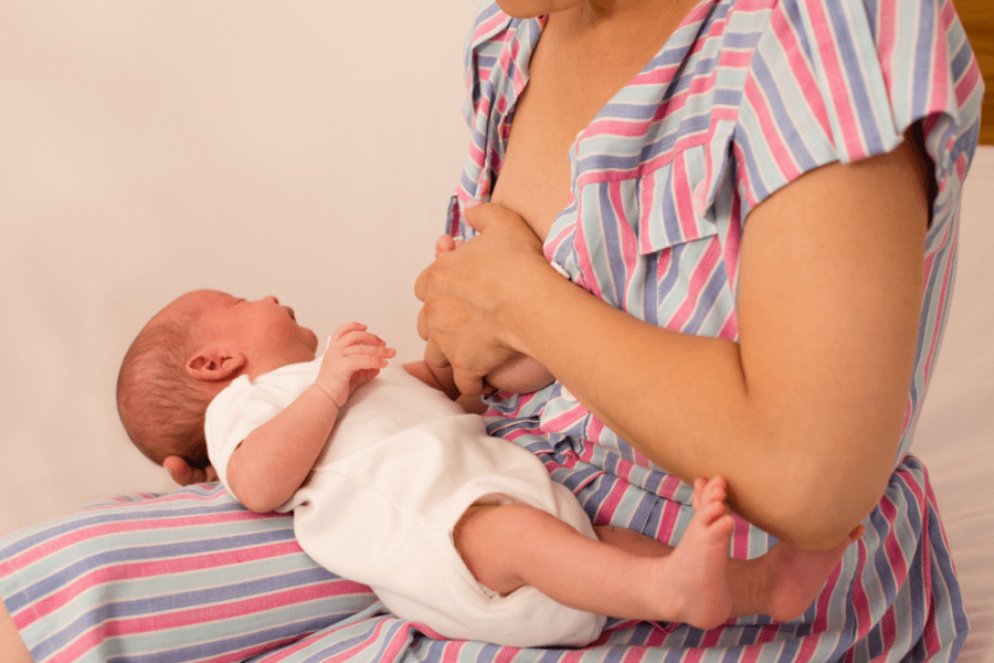 Mother covers nipple, baby screams, both experience pain from thrush.