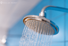 Spraying shower head with blue background