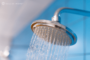 Spraying shower head with blue background