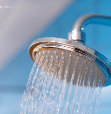 Spraying shower head with blue background