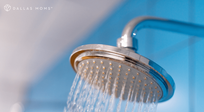 Spraying shower head with blue background