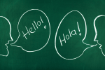 Chalkboard with talking bubbles that say "Hello!" and "Hola!" to raise a bilingual child.