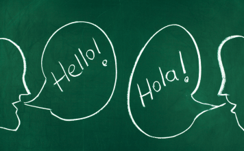 Chalkboard with talking bubbles that say "Hello!" and "Hola!" to raise a bilingual child.