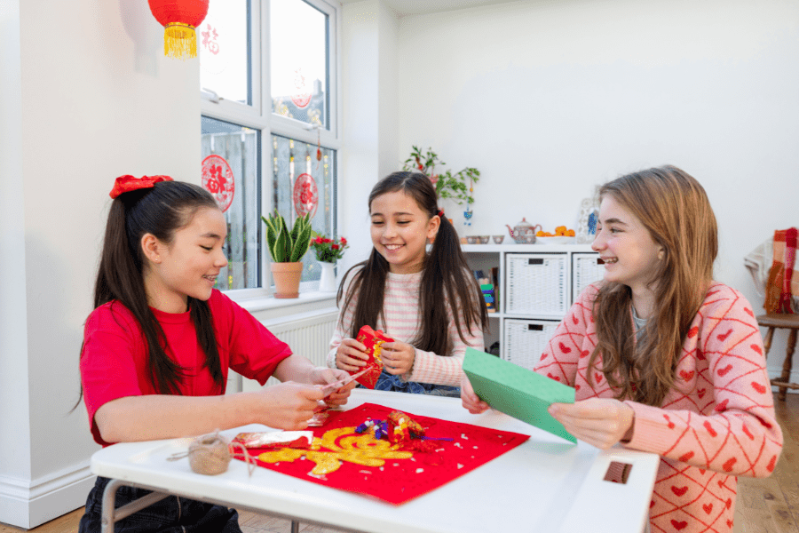 Girls do a cultural craft together.