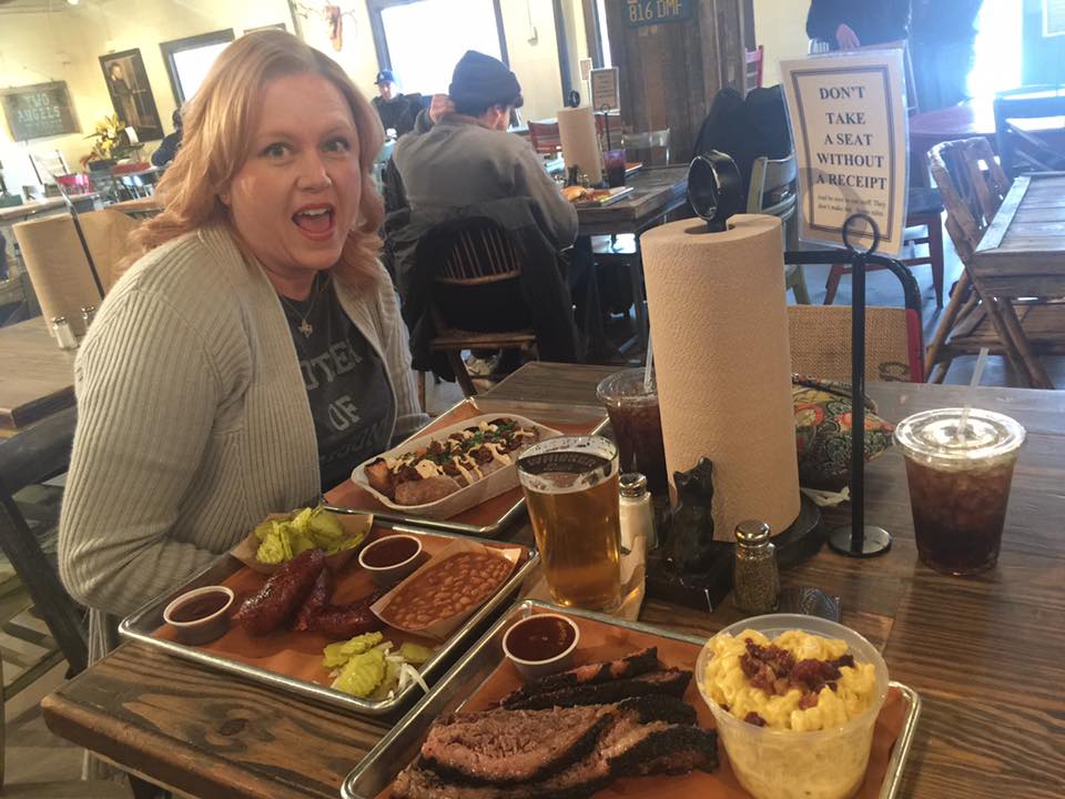 woman enjoying bbq, best bbq brisket in dallas