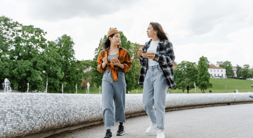 Women walking, talking, and eating together.