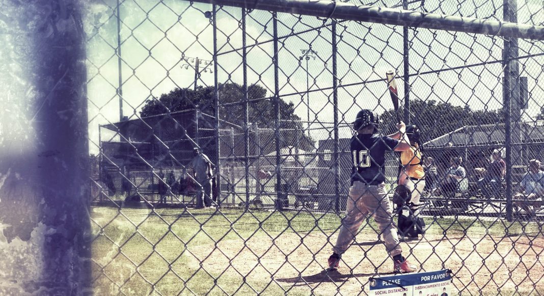 A boy stands at bat.