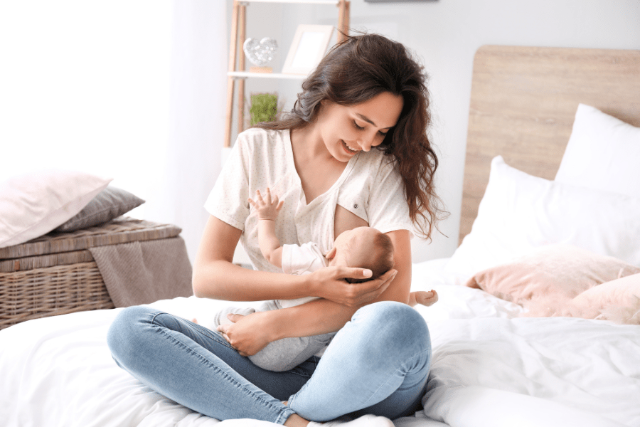 Mother wears breastfeeding-friendly blouse to make breastfeeding easier.