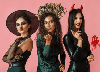 Women dressed up in Halloween costumes as a witch, Medusa, and the devil.