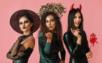 Women dressed up in Halloween costumes as a witch, Medusa, and the devil.