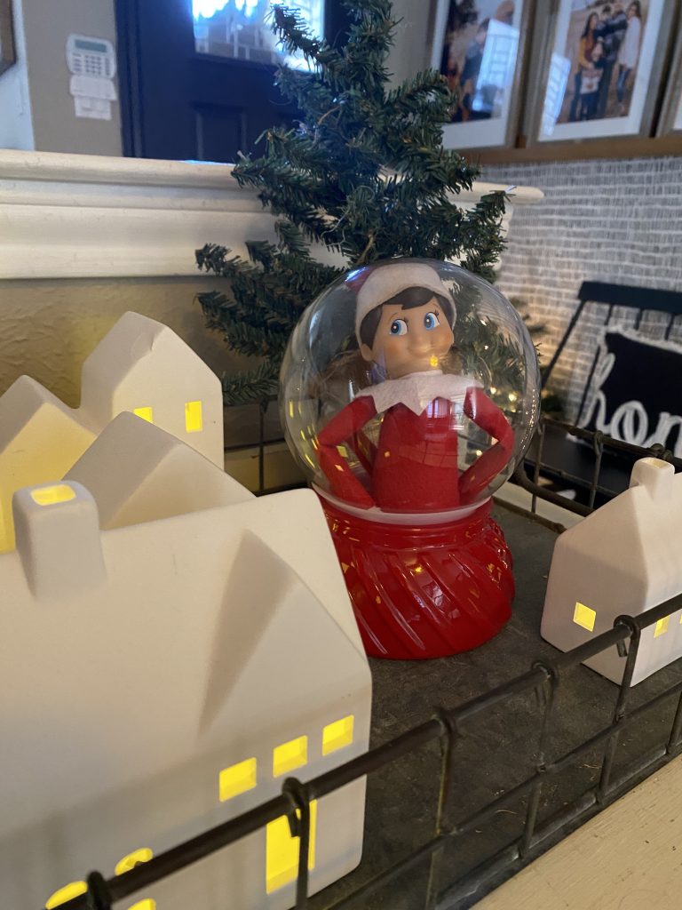 elf on the shelf ideas: elf in a snow globe