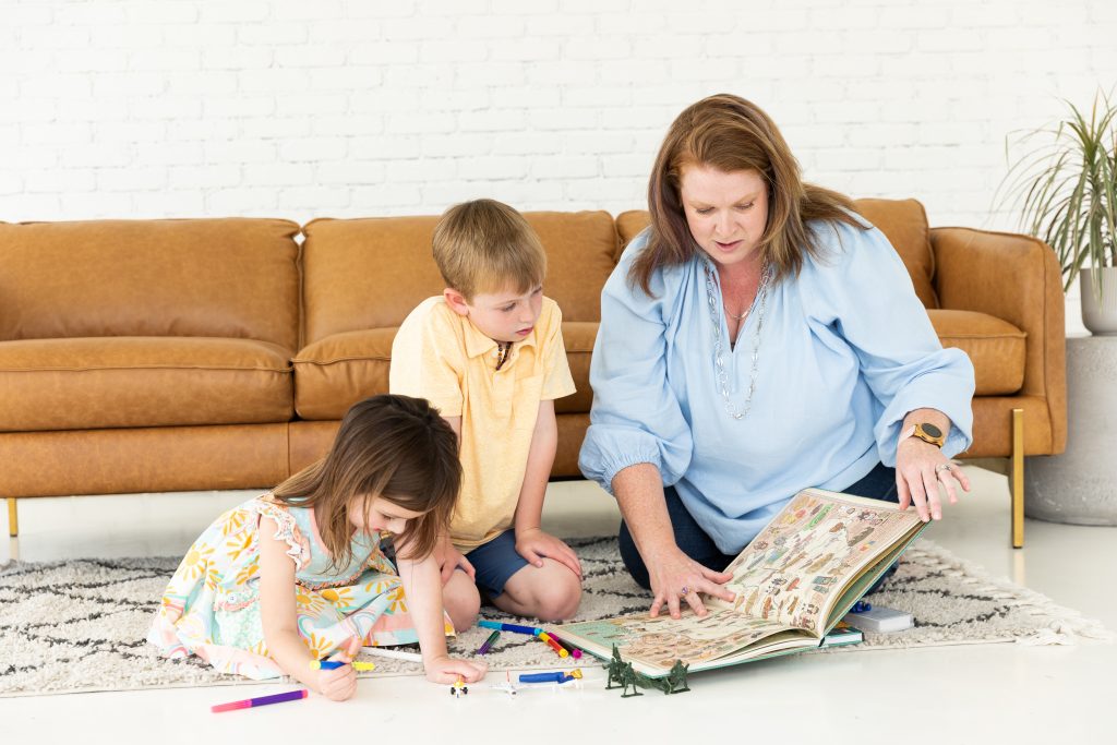 mom reading to 2 kids while they play, talking to kids about the war in Ukraine