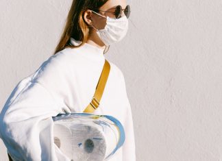 woman in mask holding toilet paper, pandemic life