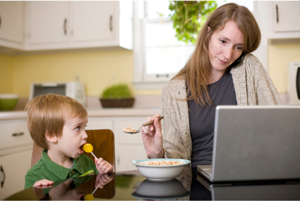 Distracted Mom Feeding Son