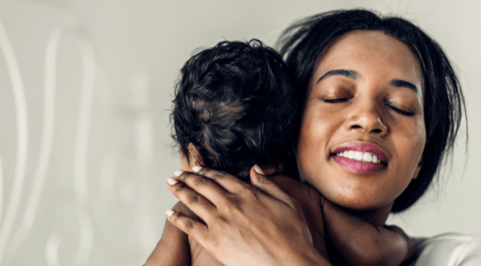 Mom breathes a sigh of relief as she holds and burps baby.