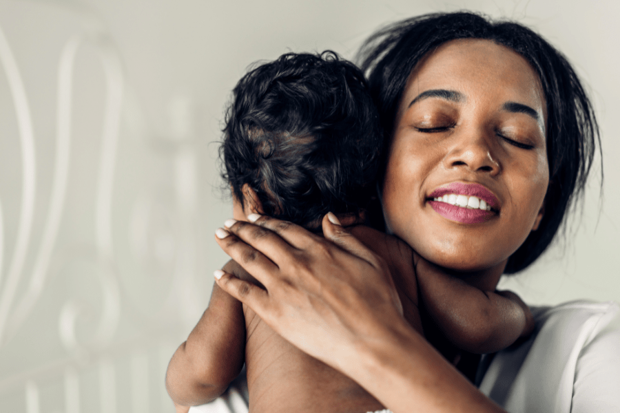 Mom breathes a sigh of relief as she holds and burps baby.