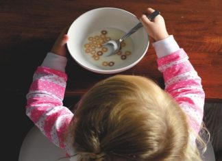 toddler with cereal bowl