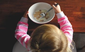 toddler with cereal bowl