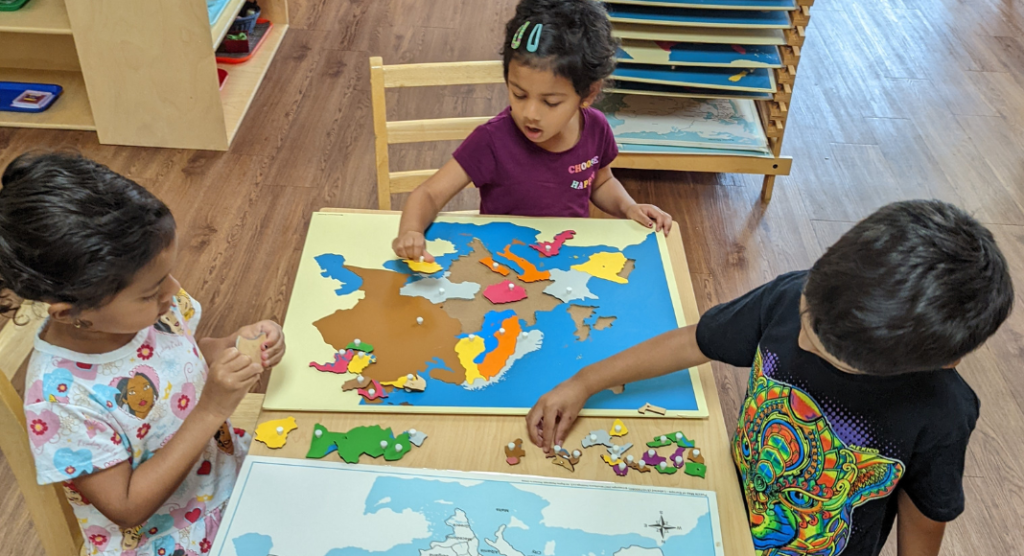 kids doing a puzzle at Wonderland Montessori