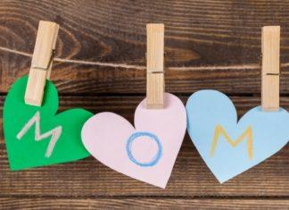 Three hearts, cut out of construction paper, hang on a clothes pins and spell "mom" written in crayon.