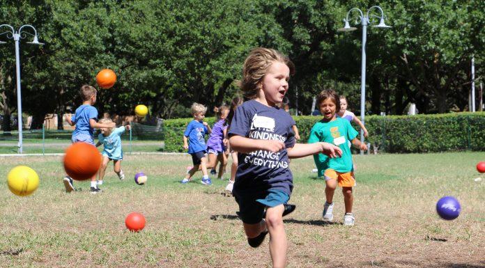 A child runs outside playing with other kids.