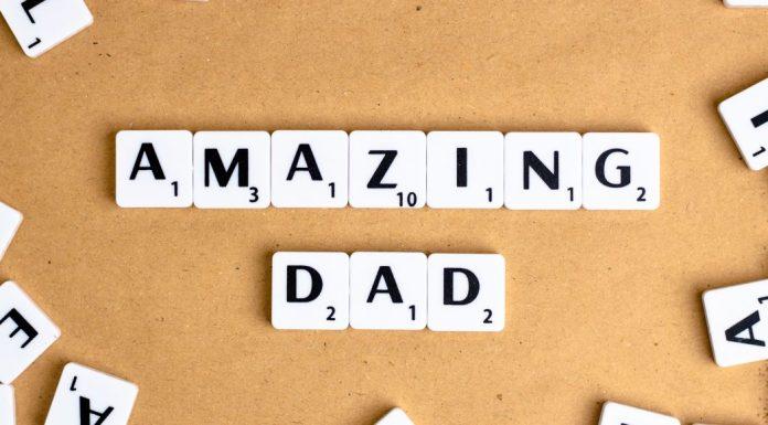 Ten white tiles with black writing spell Amazing Dad with a corkboard background.