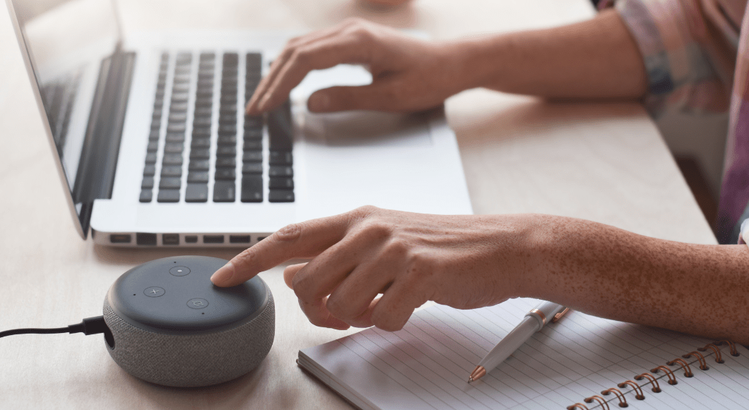 A woman presses a button on Alexa device.