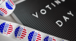 Voting day letter board with I voted stickers on table.