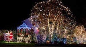 Christmas lit trees and a Santa sleigh at a decorated gazebo.