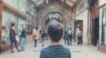 Child looks around a busy museum.