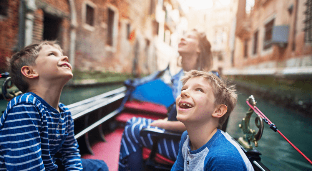 Kids ride a gondola in Italy.