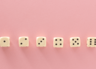 6 dice in a row on a pink background showing dots from 1-6