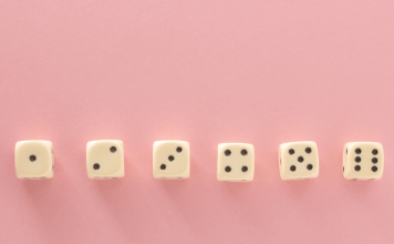 6 dice in a row on a pink background showing dots from 1-6