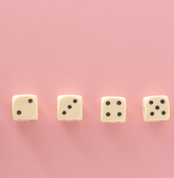 6 dice in a row on a pink background showing dots from 1-6