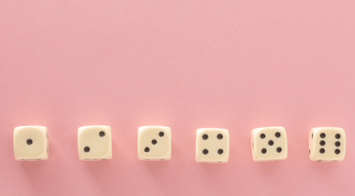 6 dice in a row on a pink background showing dots from 1-6