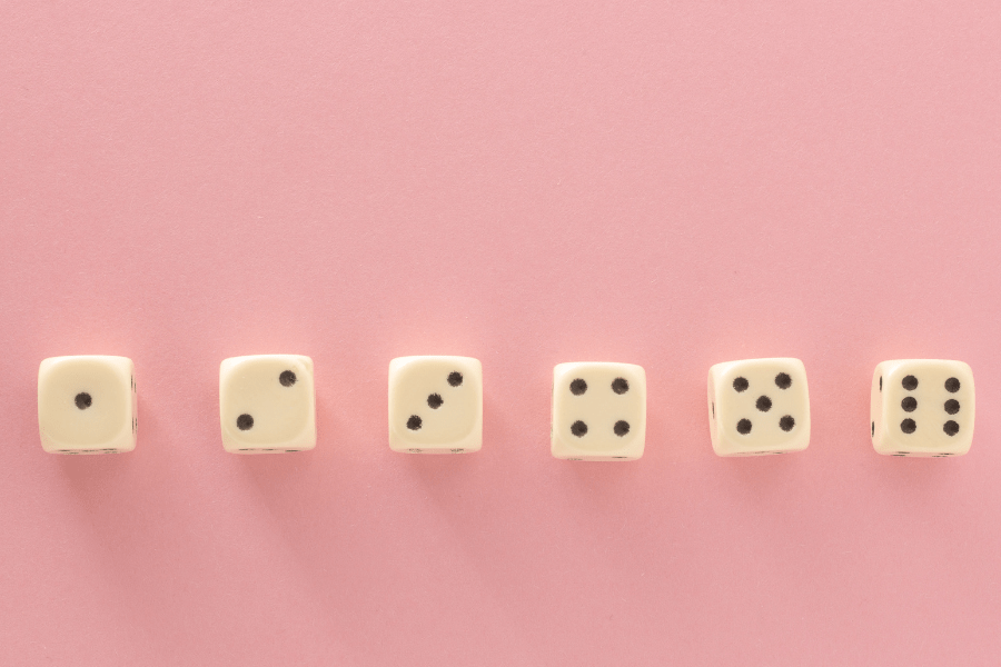 6 dice in a row on a pink background showing dots from 1-6