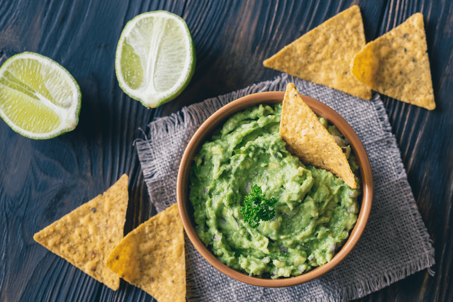 Guacamole, limes, and chips for happy hour