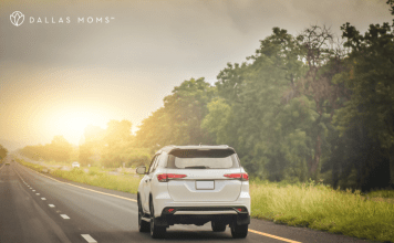 Car drives down the highway on a family road trip.