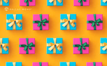 Presents wrapped in pink and blue with gold and green ribbons sit on a bright orange surface.