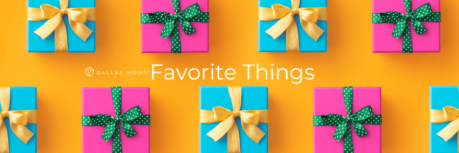 Presents wrapped in pink and blue with gold and green ribbons sit on a bright orange surface.